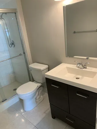 a bathroom with a sink toilet and a mirror