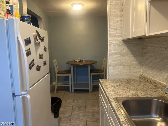 a kitchen with a stove and a refrigerator