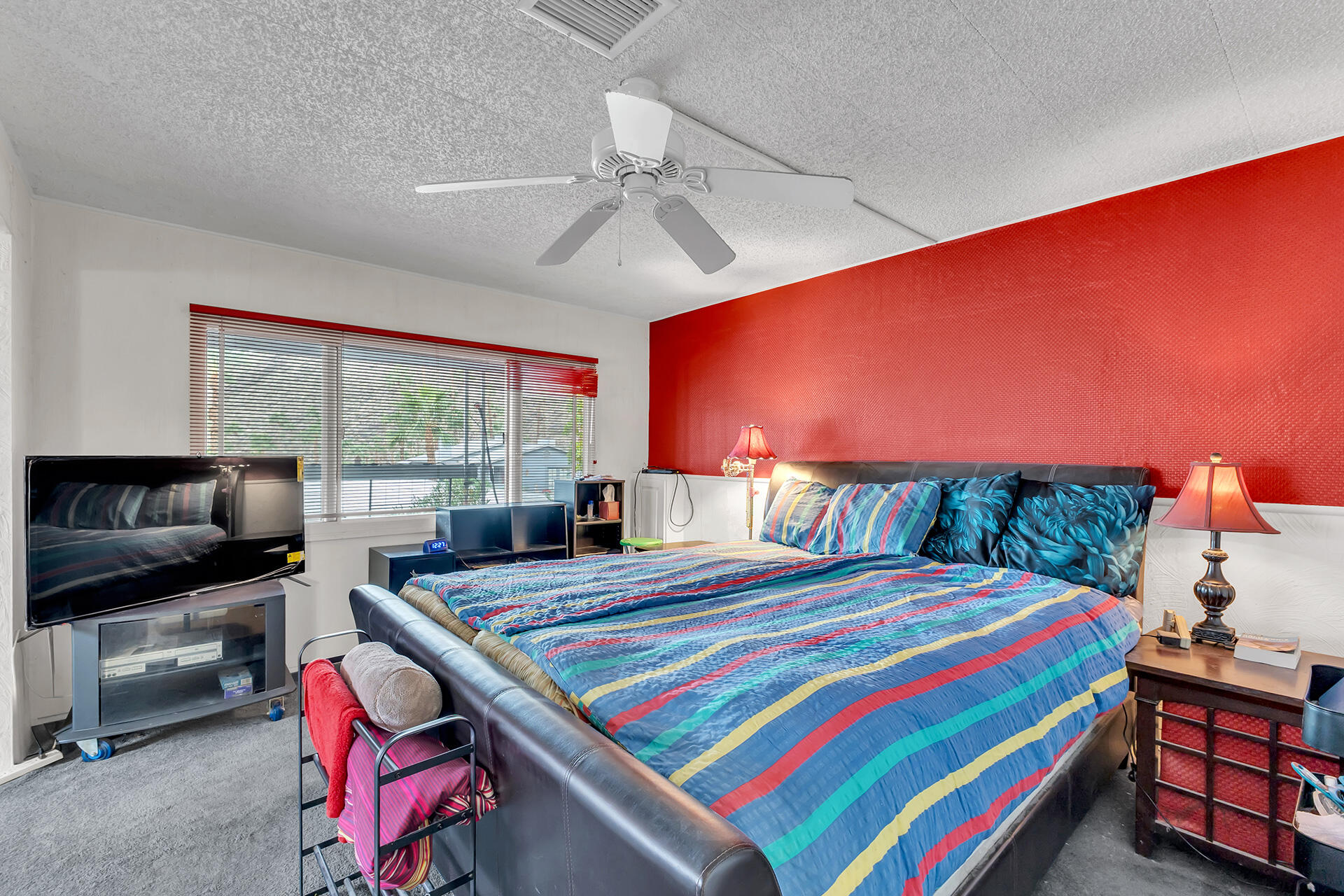 219 Stone Terrace Palm Springs, CA 92264 - Photo 16 of 41 a bedroom with a bed and a flat screen tv