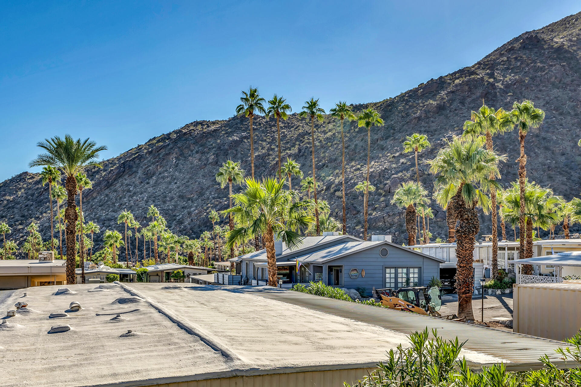 219 Stone Terrace Palm Springs, CA 92264 - Photo 26 of 41 a swimming pool with outdoor seating and covered with palm trees