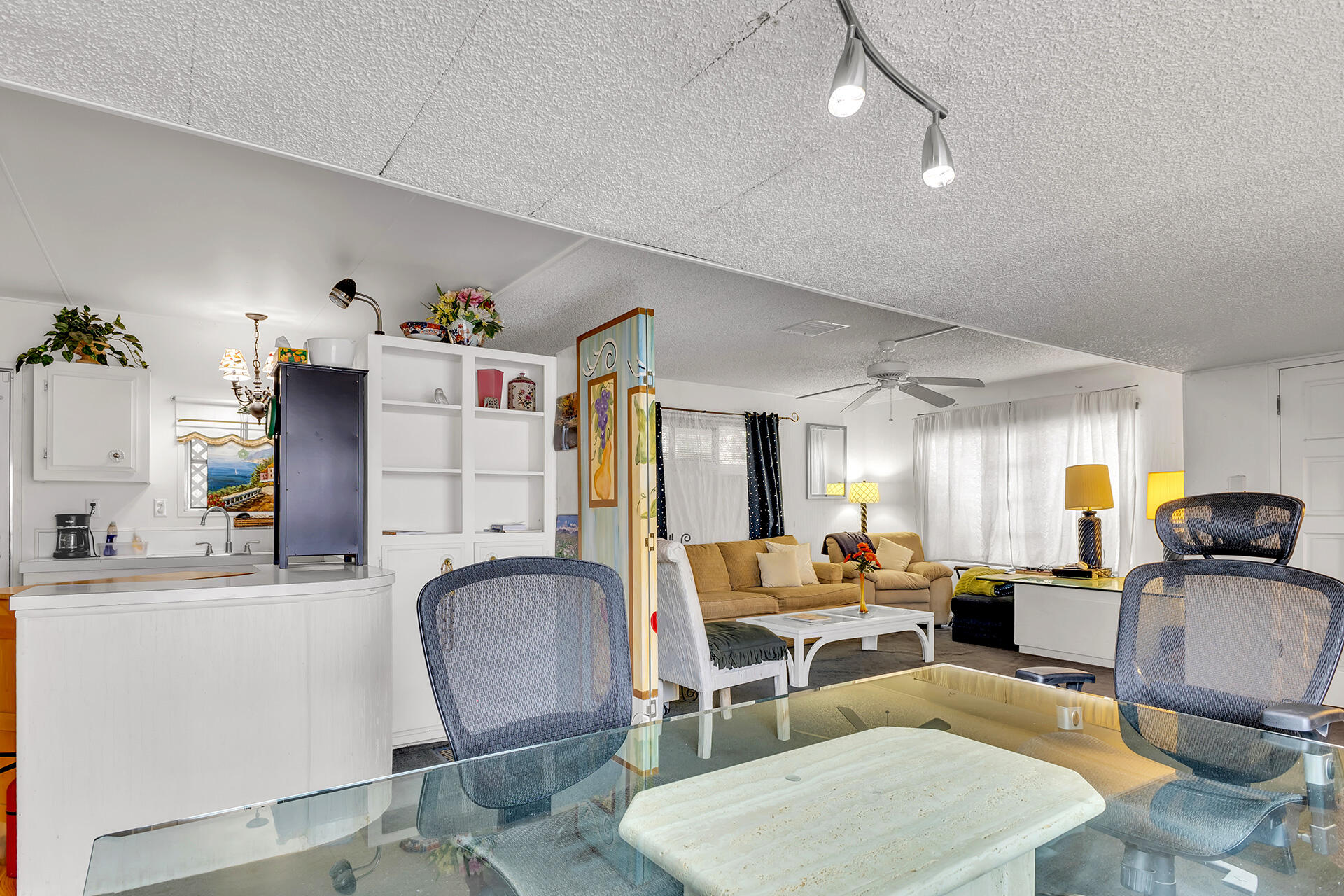 219 Stone Terrace Palm Springs, CA 92264 - Photo 28 of 41 a living room with furniture a flat screen tv and kitchen view