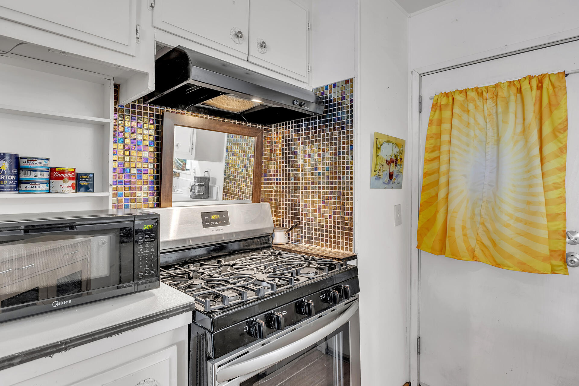 219 Stone Terrace Palm Springs, CA 92264 - Photo 32 of 41 a kitchen with stainless steel appliances granite countertop a stove and a microwave