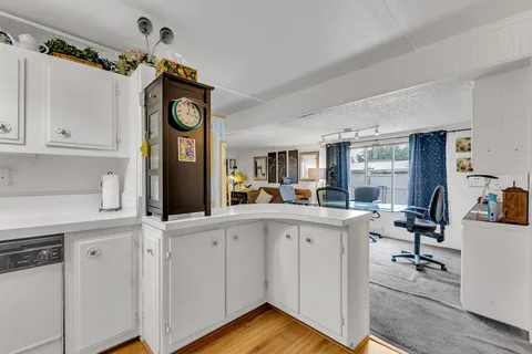 a room with table chairs and a flat screen tv
