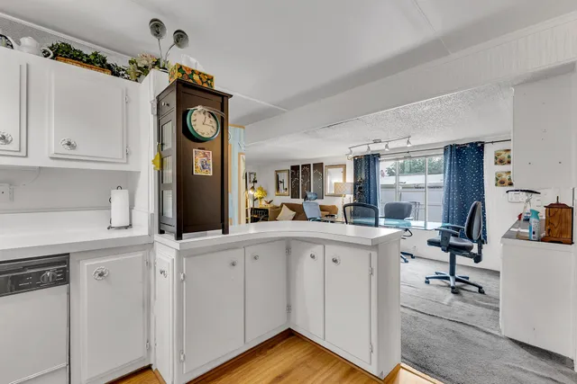 a room with table chairs and a flat screen tv