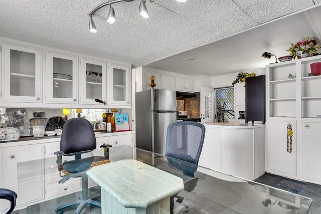 a kitchen with a sink dishwasher and white cabinets