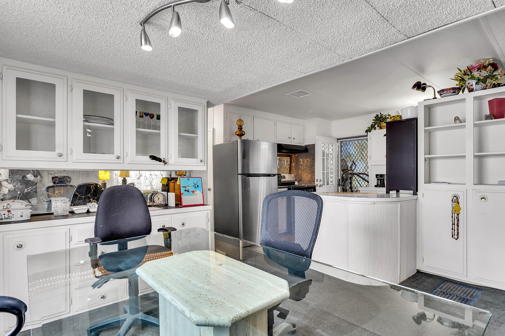 219 Stone Terrace Palm Springs, CA 92264 - Photo 9 of 41 a kitchen with stainless steel appliances granite countertop a refrigerator and a stove top oven