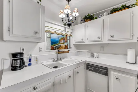 a kitchen with a sink a stove and cabinets