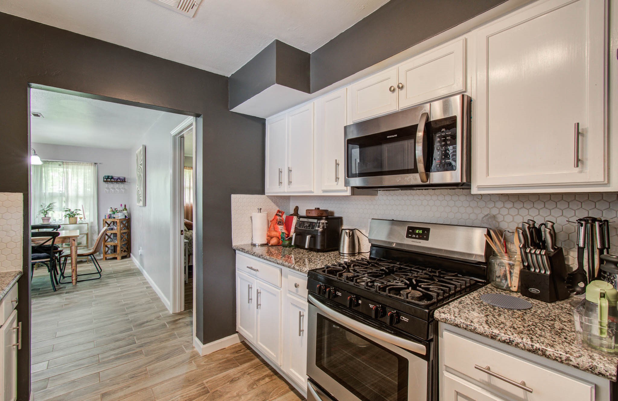1327 Fallbrook Drive Houston, TX 77038 - Photo 13 of 34 a kitchen with stainless steel appliances granite countertop a stove and a microwave
