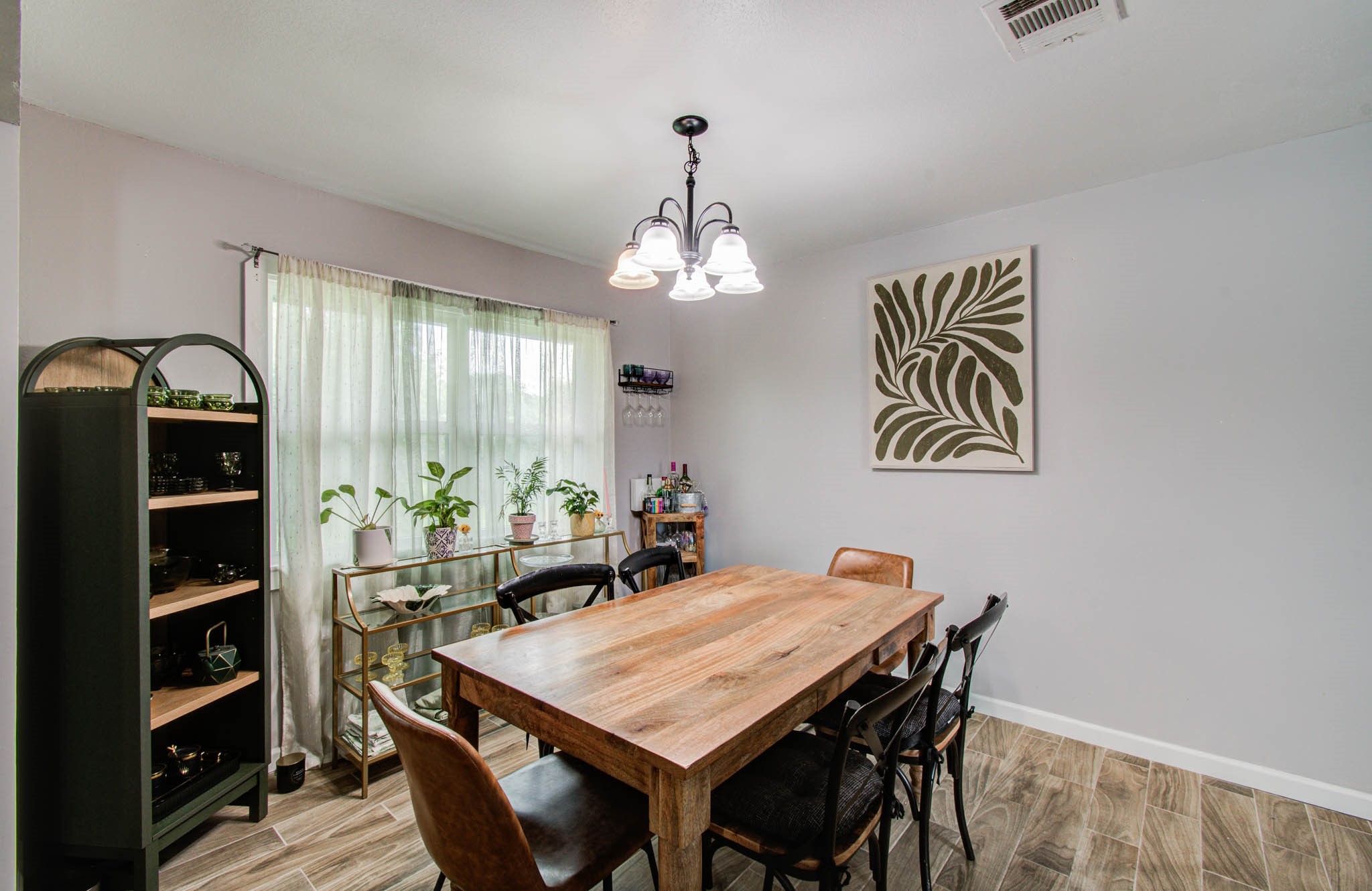 1327 Fallbrook Drive Houston, TX 77038 - Photo 16 of 34 a view of a dining room with furniture and chandelier