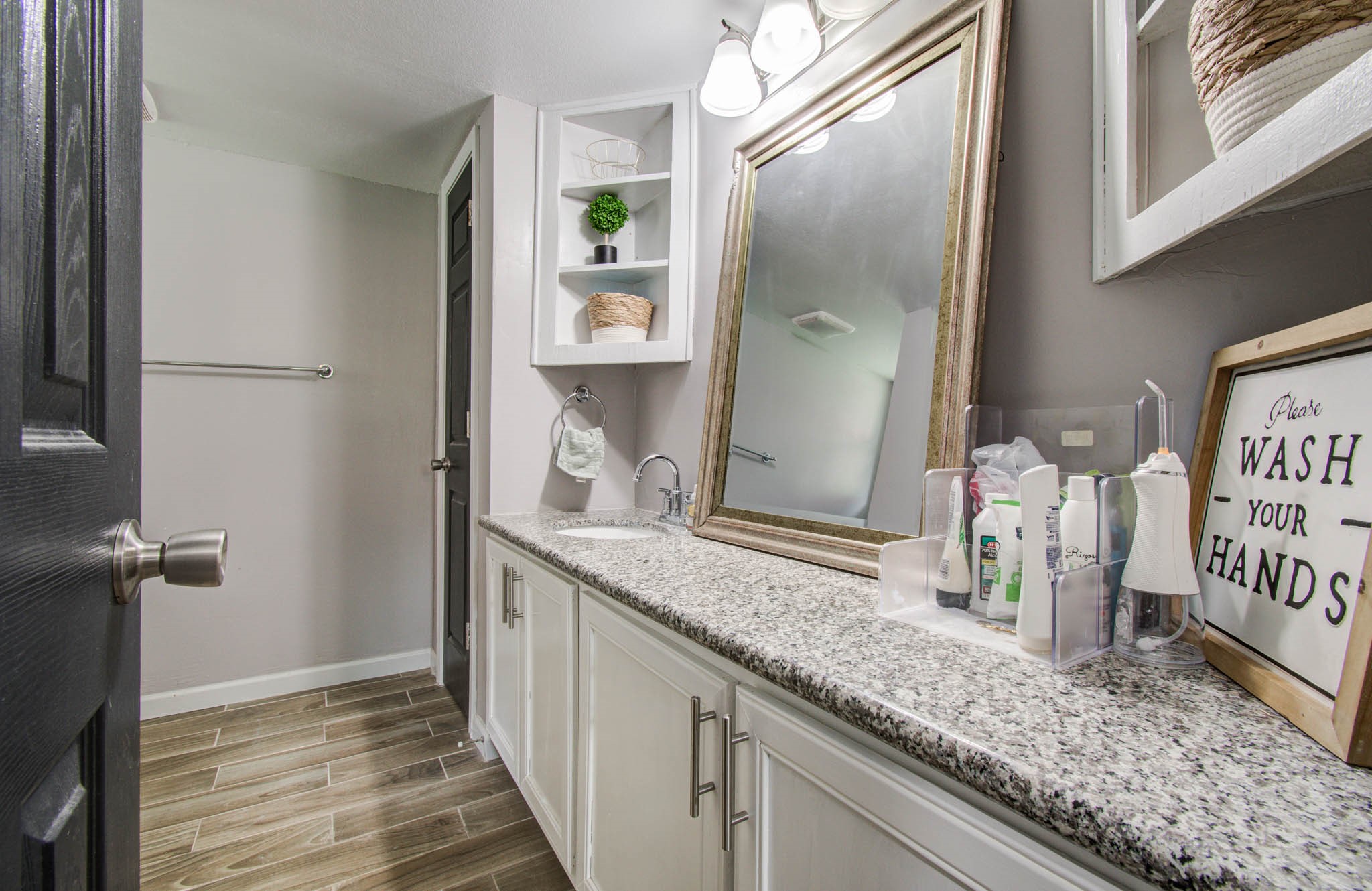 1327 Fallbrook Drive Houston, TX 77038 - Photo 19 of 34 a bathroom with a granite countertop sink and a mirror