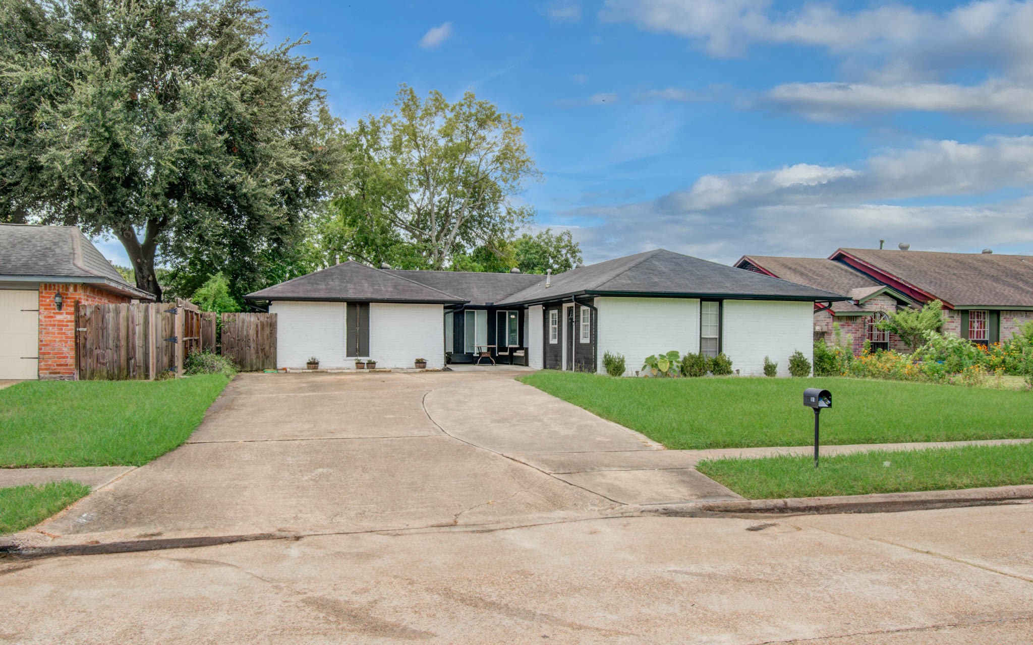 1327 Fallbrook Drive Houston, TX 77038 - Photo 2 of 34 a front view of a house with a garden and plants