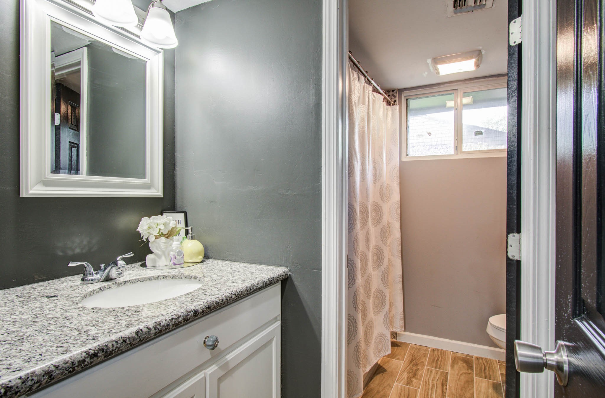 1327 Fallbrook Drive Houston, TX 77038 - Photo 25 of 34 a bathroom with a granite countertop sink and a mirror