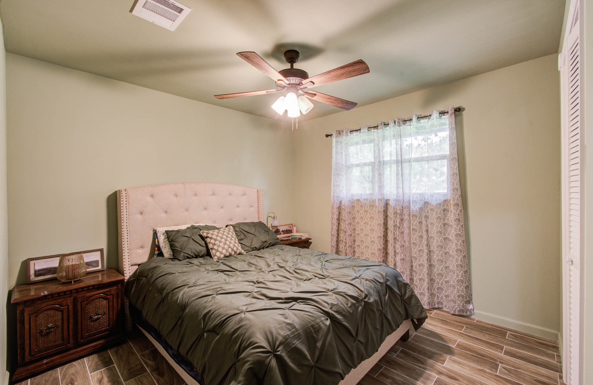 1327 Fallbrook Drive Houston, TX 77038 - Photo 26 of 34 a bedroom with a bed and a chandelier