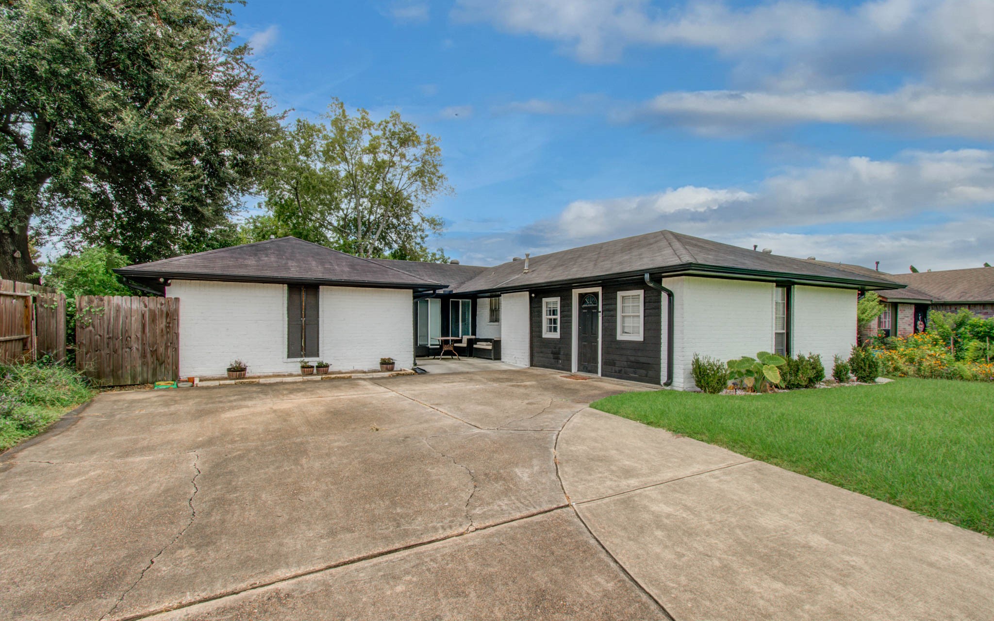 1327 Fallbrook Drive Houston, TX 77038 - Photo 3 of 34 a front view of a house with a garden and trees