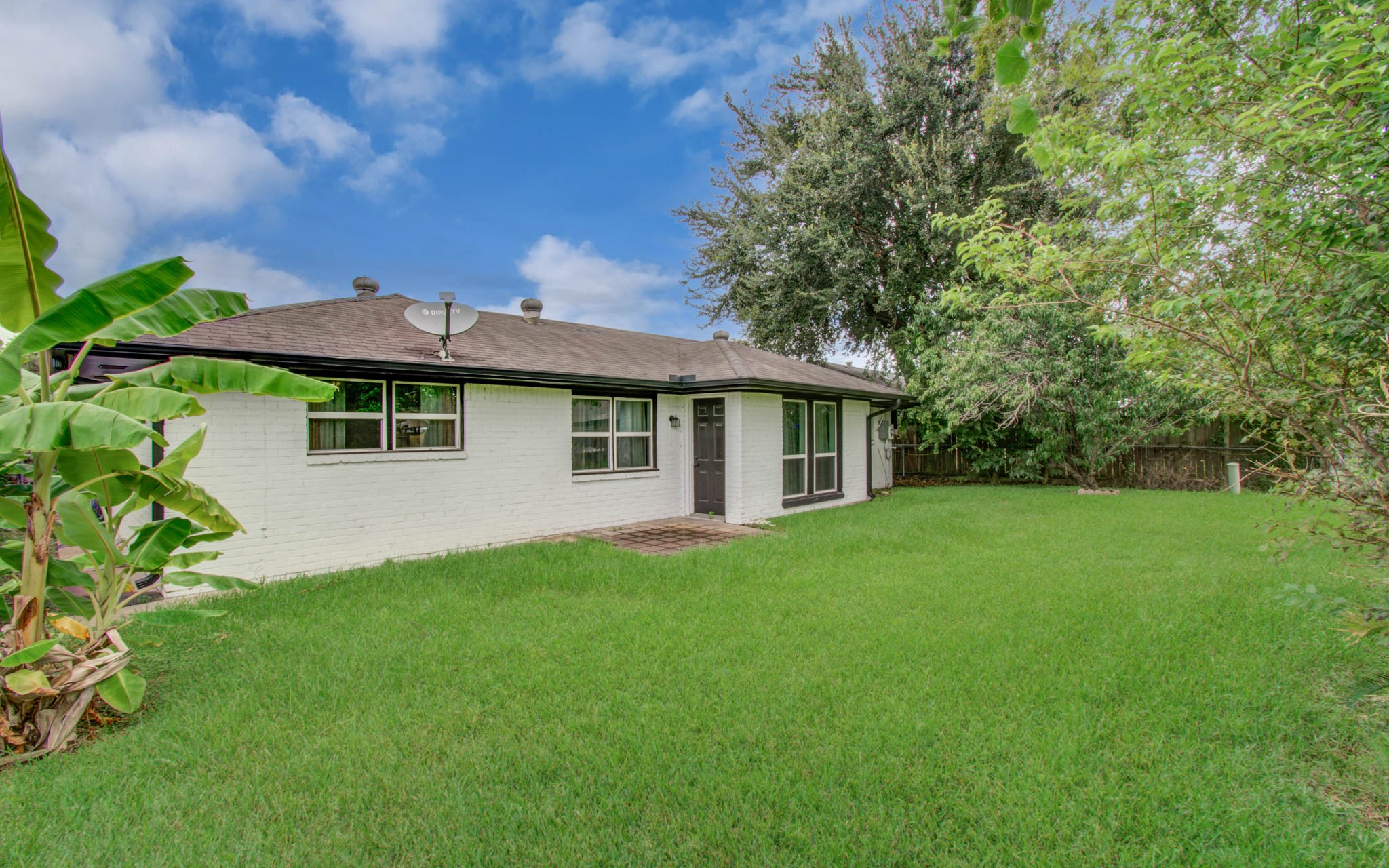 1327 Fallbrook Drive Houston, TX 77038 - Photo 32 of 34 a front view of a house with a garden