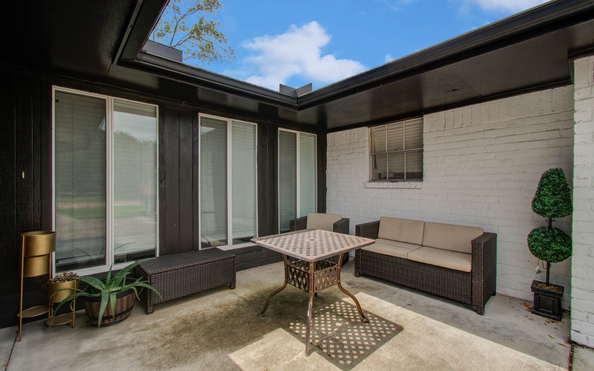 1327 Fallbrook Drive Houston, TX 77038 - Photo 4 of 34 a outdoor living space with furniture and a potted plant