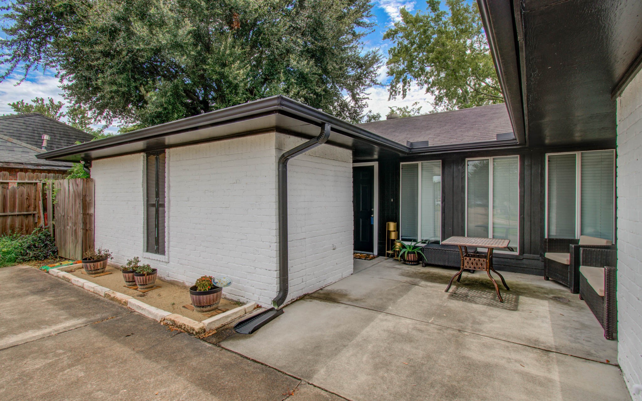1327 Fallbrook Drive Houston, TX 77038 - Photo 5 of 34 a backyard of a house with table and chairs