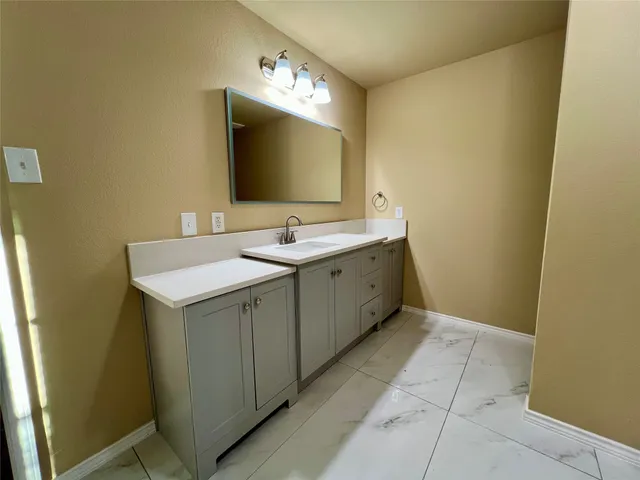 a bathroom with a double vanity sink and mirror