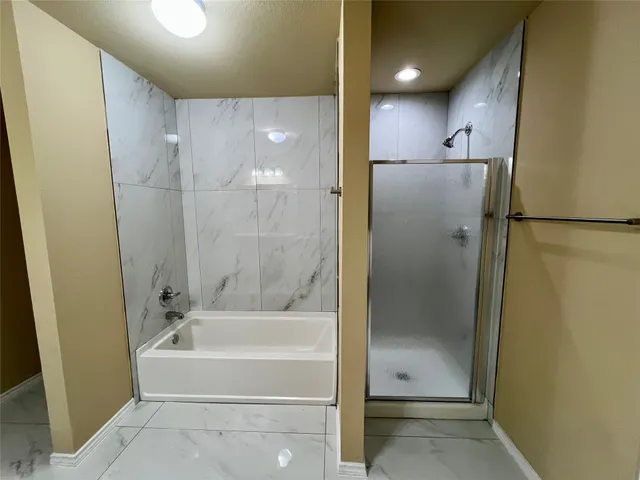 a bathroom with a bathtub and a shower