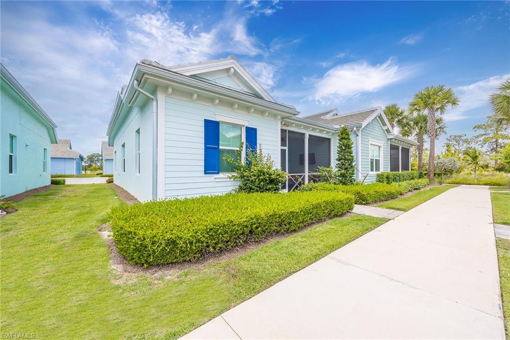 7204 Cayo Coco Lane Naples, FL 34113 - Photo 1 of 22 a view of a house with brick walls plants and large tree