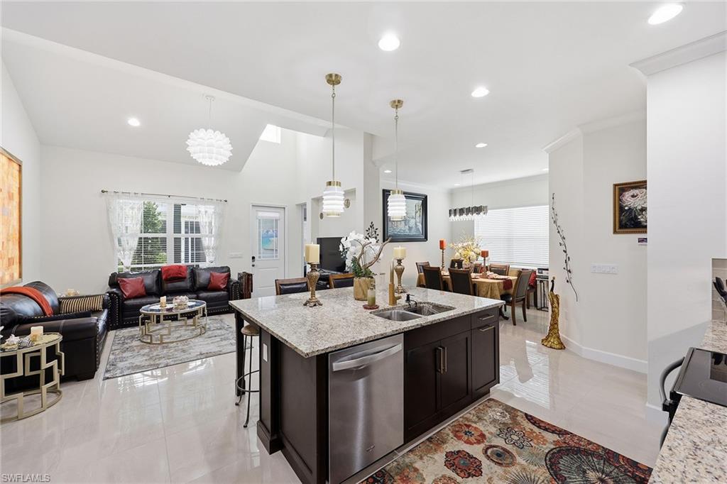 7204 Cayo Coco Lane Naples, FL 34113 - Photo 13 of 22 a open kitchen with stainless steel appliances granite countertop a sink dishwasher and a stove with wooden floor