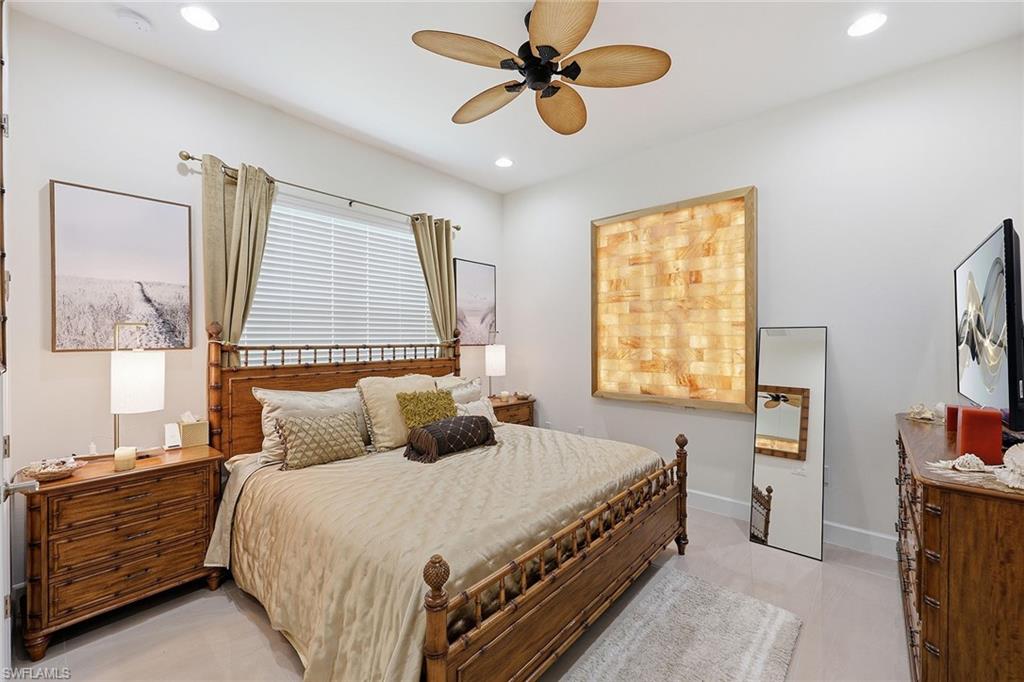 7204 Cayo Coco Lane Naples, FL 34113 - Photo 15 of 22 a bedroom with a bed and a window