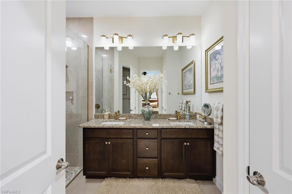 7204 Cayo Coco Lane Naples, FL 34113 - Photo 16 of 22 a bathroom with a double vanity sink and mirror