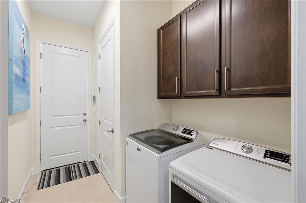 7204 Cayo Coco Lane Naples, FL 34113 - Photo 20 of 22 a view of a storage and utility room with washer and dryer