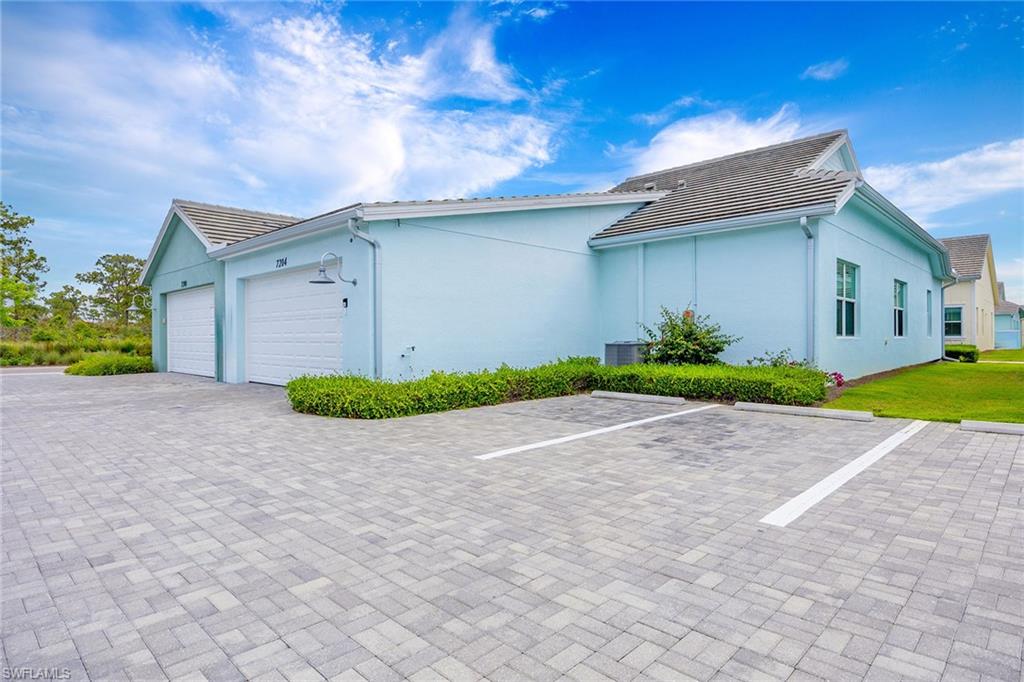 7204 Cayo Coco Lane Naples, FL 34113 - Photo 21 of 22 a view of a house with a yard and large tree