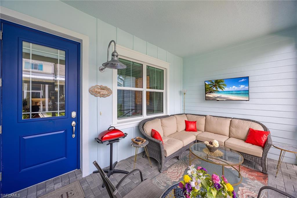 7204 Cayo Coco Lane Naples, FL 34113 - Photo 3 of 22 a living room with patio furniture and a potted plant