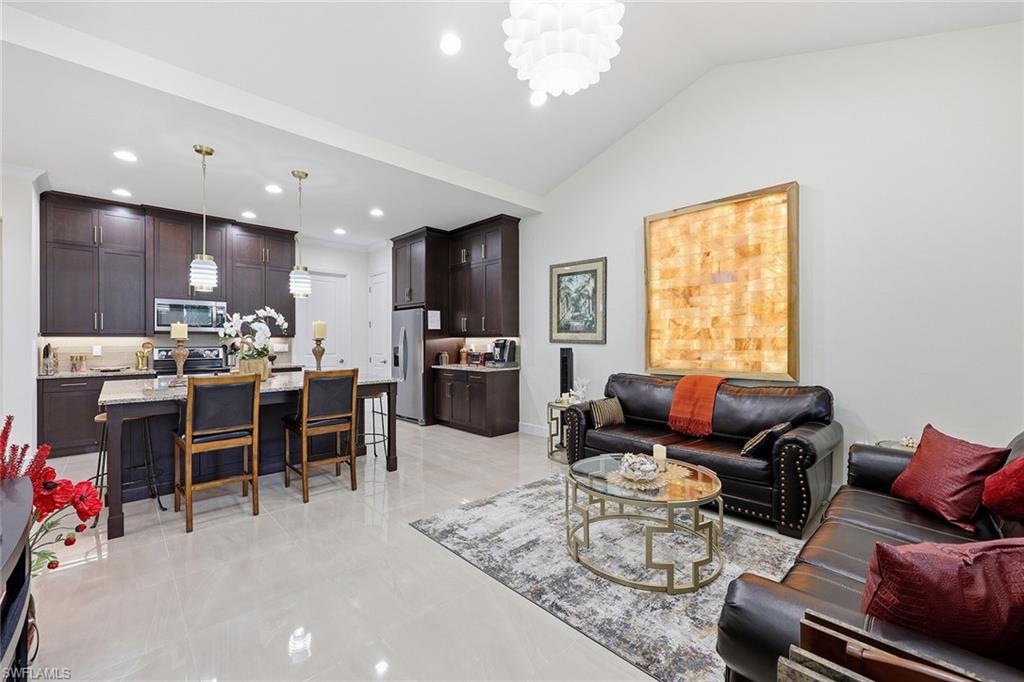 7204 Cayo Coco Lane Naples, FL 34113 - Photo 5 of 22 a living room with furniture kitchen area and a window