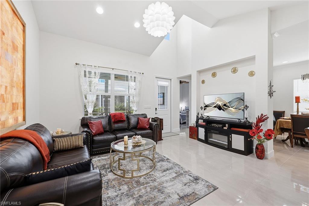 7204 Cayo Coco Lane Naples, FL 34113 - Photo 6 of 22 a living room with furniture chess table and a window