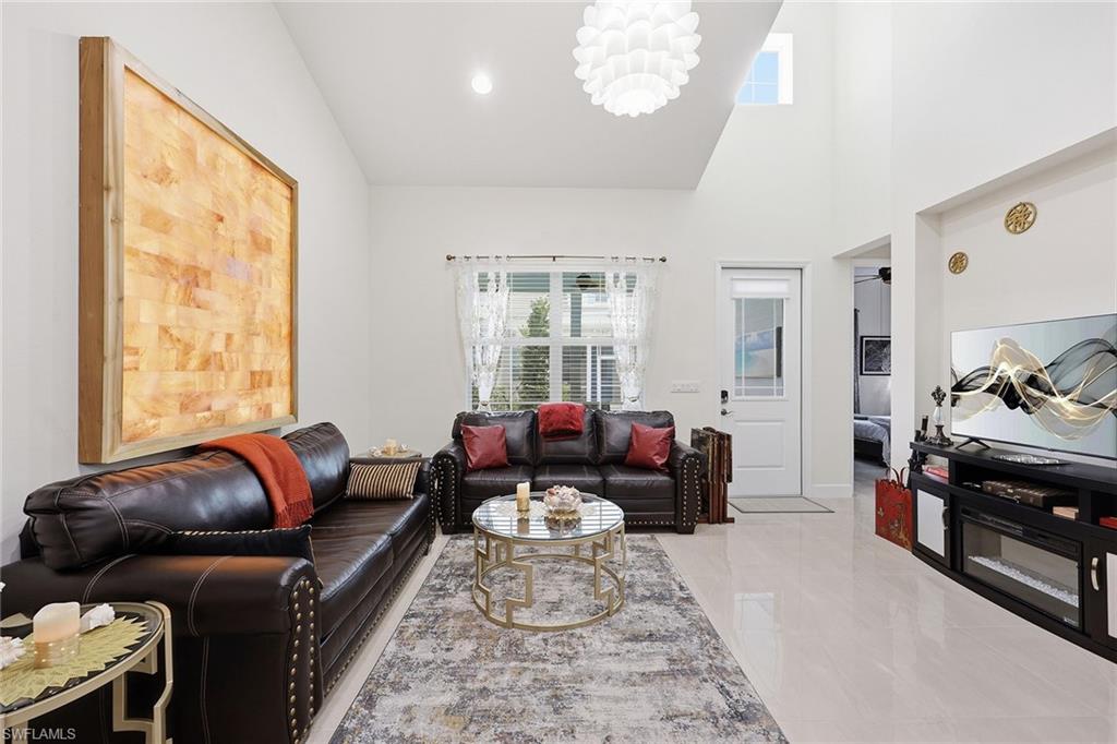 7204 Cayo Coco Lane Naples, FL 34113 - Photo 7 of 22 a living room with furniture and a large window
