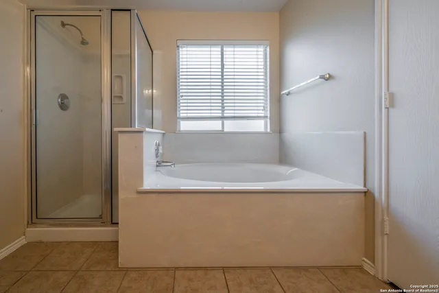 a white bath tub sitting in a bathroom next to a window