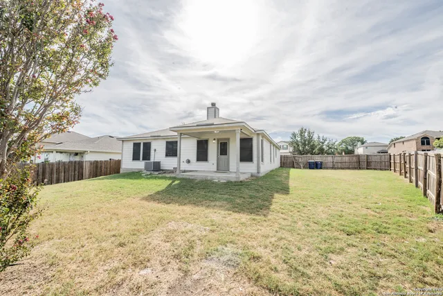 a front view of a house with a yard table and chairs