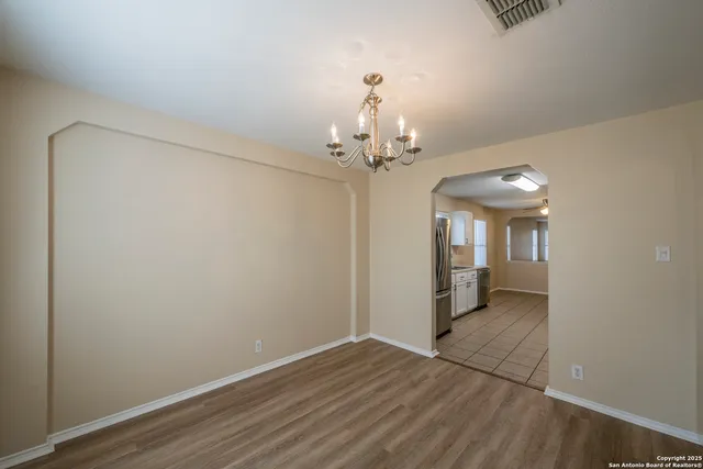 wooden floor in an empty room with a mirror