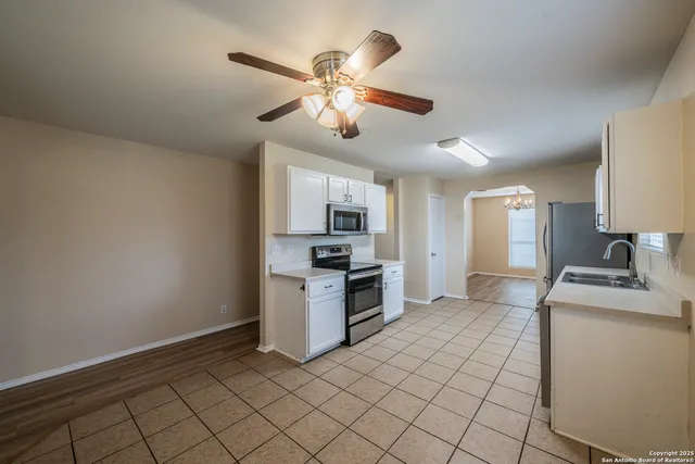 a kitchen with granite countertop a sink and stainless steel appliances
