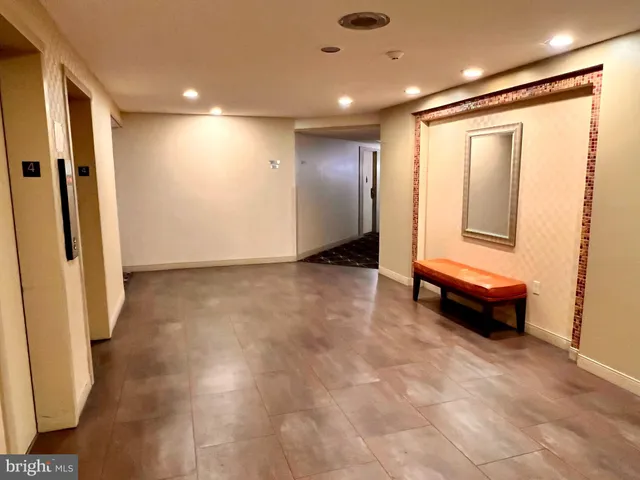 a view of a living room with a table and chairs