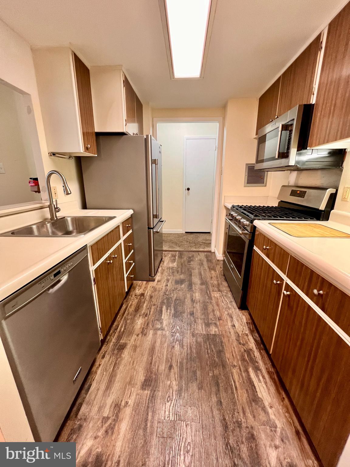 100 West Avenue, Unit 418S Jenkintown, PA 19046 - Photo 4 of 18 a kitchen with stainless steel appliances granite countertop a stove a sink and a refrigerator