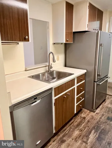 a kitchen with wooden cabinets and stainless steel appliances