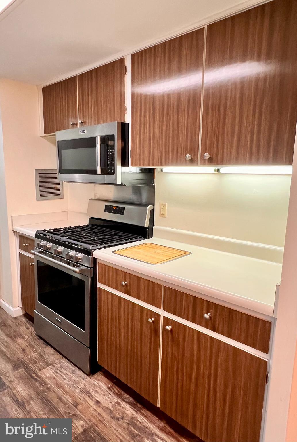 100 West Avenue, Unit 418S Jenkintown, PA 19046 - Photo 6 of 18 a kitchen with wooden cabinets and stainless steel appliances