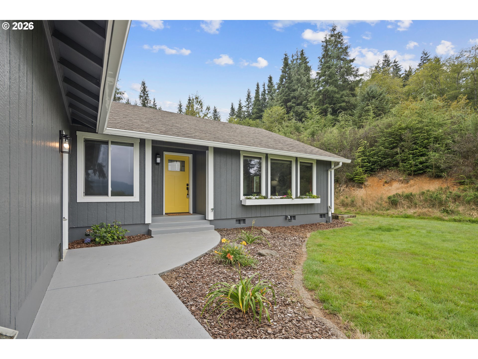 650 Marvin Road Tillamook, OR 97141 - Photo 3 of 48 a front view of a house with garden