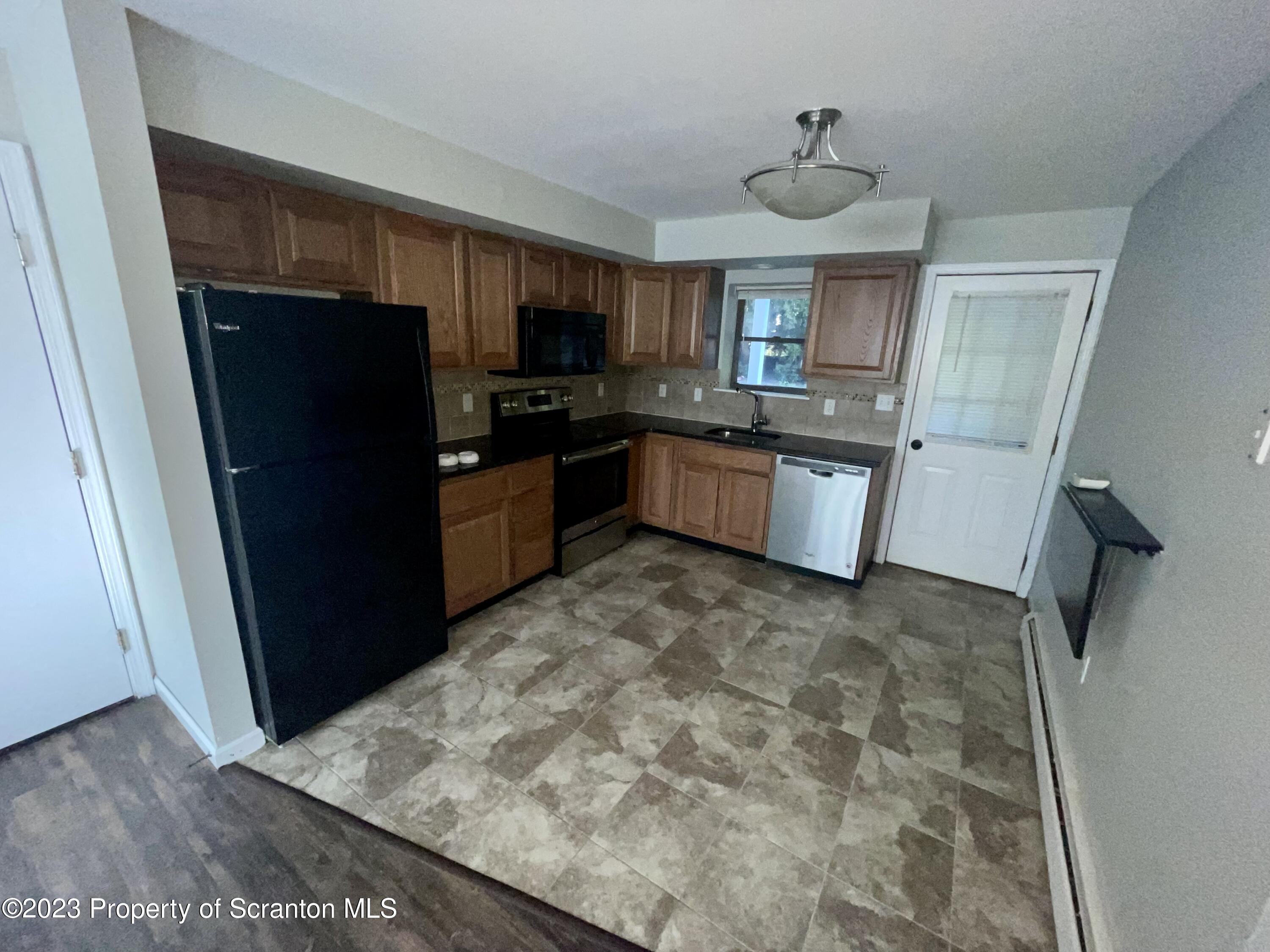 118 1/2 Frank Street, Unit B Dunmore, PA 18512 - Photo 4 of 15 a kitchen with a refrigerator and a sink