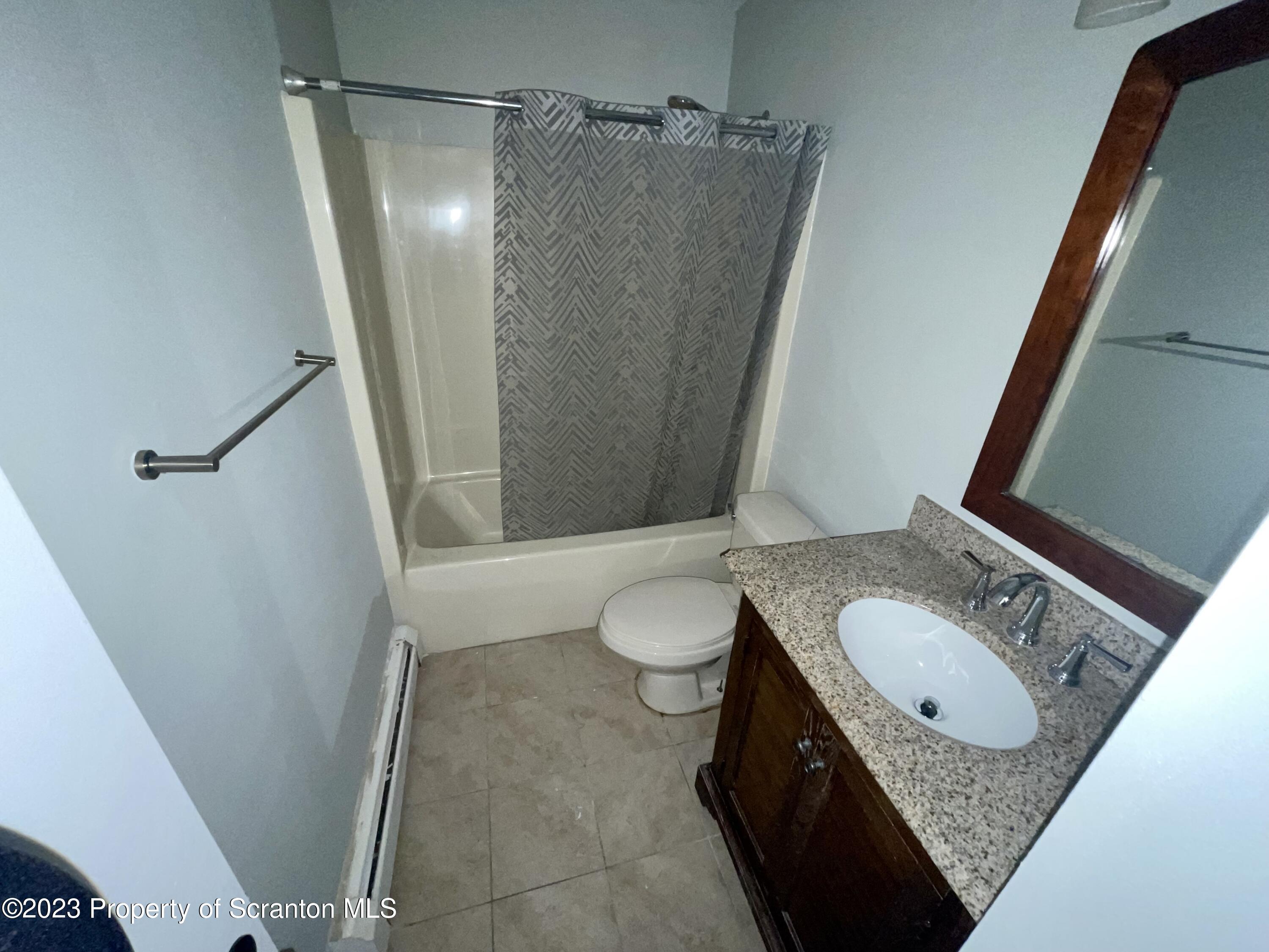 118 1/2 Frank Street, Unit B Dunmore, PA 18512 - Photo 8 of 15 a bathroom with a granite countertop sink toilet and shower