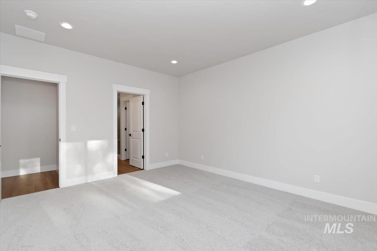 3321 Helios Street Caldwell, ID 83607 - Photo 17 of 35 Spacious room featuring light-colored carpeting, recessed lighting, and crisp white baseboards