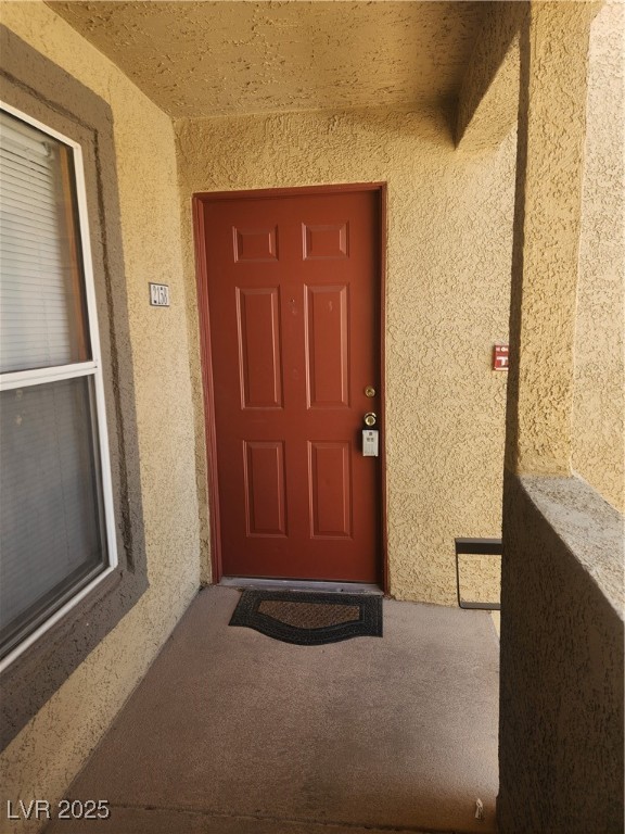 Doorway entry  to property with stucco siding