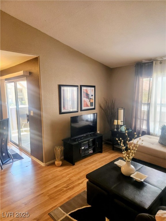 2300 East Silverado Ranch Boulevard, Unit 2158 Las Vegas, NV 89123 - Photo 5 of 19 Living room featuring a textured wall, light wood