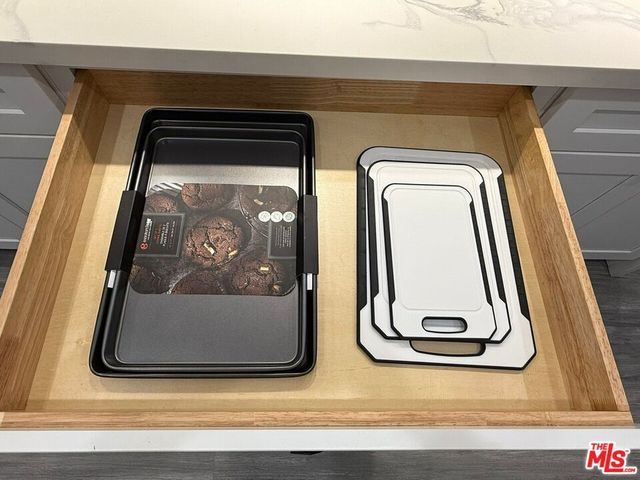 a spacious bedroom with a bed and chair