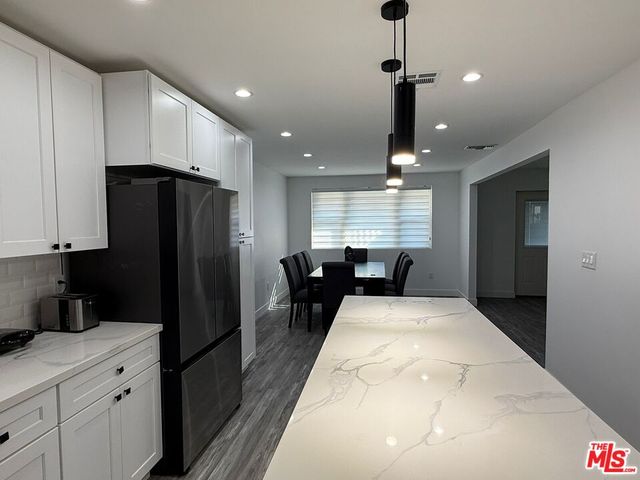 a kitchen with refrigerator and window