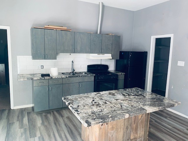 284 County Road 3405 Cleveland, TX 77327 - Photo 11 of 22 a kitchen with kitchen island sink refrigerator and cabinets